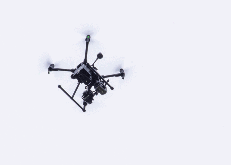 View of the bottom of a black drone flying against a gray sky as part of a new project for the Ohio Department of Transportation.