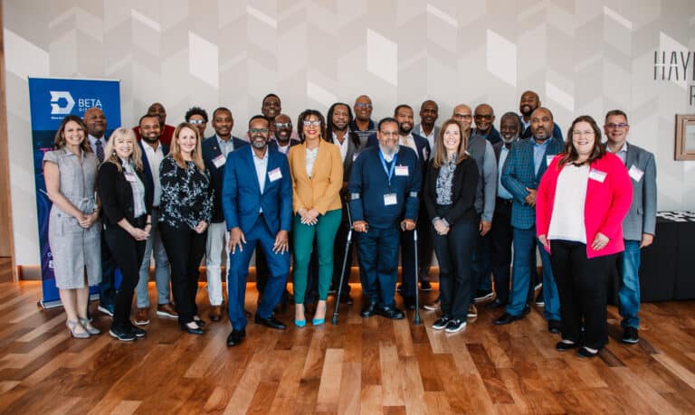 Mobility in Color attendees stand and smile for a group photo.